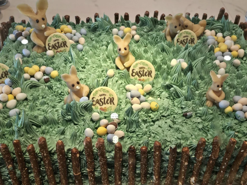 Rotterdam Cruise Port: Our Complete Guide + Insider Tips 2026 (Visited 5 Times Since 2022 by Danny and Peter) 4 Cruising with Danny and Peter, Holland America Line, Nieuw Statendam, Rotterdam, The Netherlands, Voyage Rotterdam Nieuw Statendam Embarkation | A vibrant collage capturing embarkation day on Holland America’s Nieuw Statendam docked at Rotterdam’s Cruise Terminal, with the Erasmus Bridge and Zalmhaventoren in the background under a golden afternoon sky. The ship’s elegant atrium sparkles with a chandelier, while a cozy Oceanview Family Cabin showcases bunk beds and large windows framing the Nieuwe Maas. A family tours the Lido Market, where tables overflow with herb-crusted lamb, chocolate eggs, and colorful desserts for Easter lunch. On deck, two teenagers snap selfies against Rotterdam’s twinkling skyline during sail away, the ship gliding past the illuminated Swan Bridge. In the Ocean Bar, friends toast with cocktails, and the Crow’s Nest lounge offers panoramic views of the river. The scene closes with a cozy cabin moment, a TV glowing with Formula 1 action, hot chocolate mugs on a table, and the gentle sway of the ship at dusk.