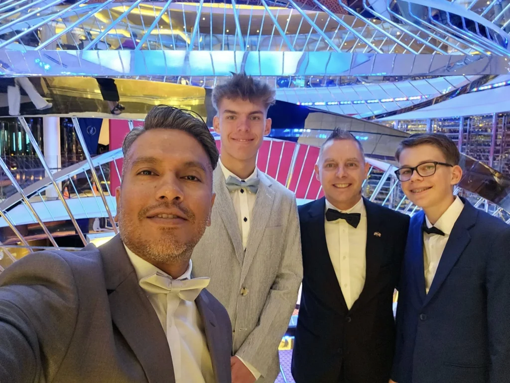 A Voyage Through Time and Tide: Exploring the English Channel Aboard Holland America Line’s Nieuw Statendam 21 Cruising with Danny and Peter, Holland America Line, Nieuw Statendam, English Channel, Sea Day, English Channel Nieuw Statendam Sea Day Experience | A luxurious scene aboard Holland America Line’s Nieuw Statendam cruising the English Channel, featuring the Main Dining Room with elegantly set tables, gourmet dishes like eggs Benedict, and large windows revealing gray-green waves; the intimate Pinnacle Grill with plush seating and a plated beef tenderloin with lobster dumplings; the World Stage theater’s circular stage and vibrant 270-degree LED screen displaying Casablanca’s Hassan II Mosque; and the ship’s sleek white hull sailing smoothly under an overcast sky, embodying modern cruising elegance.