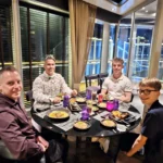 Cruising with Danny and Peter, Holland America Line, Nieuw Statendam, Bay Of Biscay History Sea Day | A scenic view of the Bay of Biscay’s deep blue waters under a partly cloudy sky, with gentle waves reflecting sunlight, alongside the elegant Dining Room of Holland America’s Nieuw Statendam, featuring white tablecloths, polished silverware, and a plate of lobster Benedict with hollandaise sauce. The World Stage theater showcases a vibrant LED screen displaying Agadir’s bustling souk with colorful spices and crafts, while the Lido Pool area glows at night with twinkling lights, where guests mingle with champagne during the Mariners Reception. The intimate Tamarind restaurant, with warm wood decor, presents a beautifully plated Penang red curry with duck, paired with a sake flight.