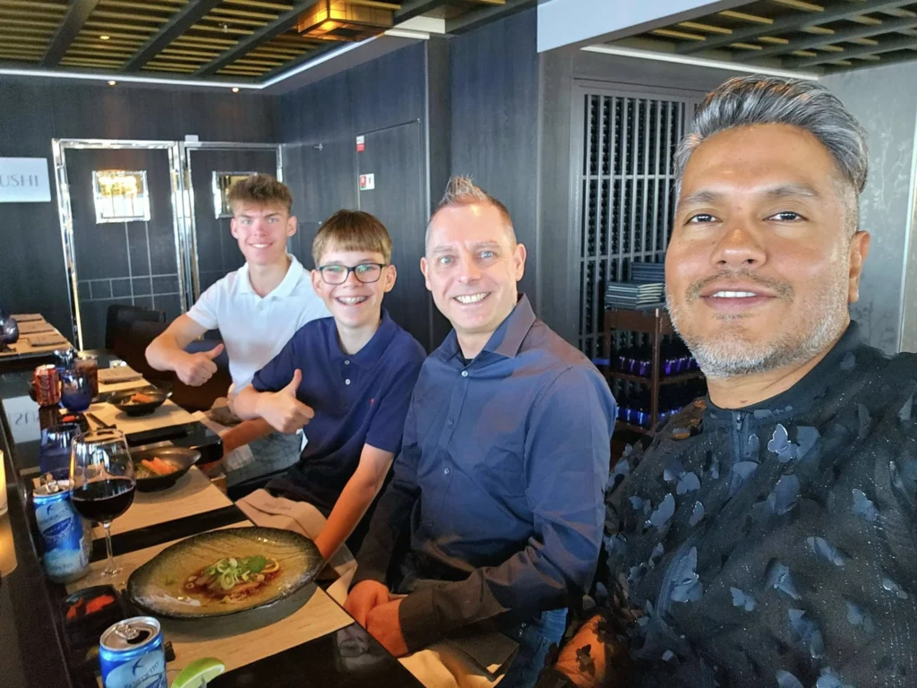 Cruising with Danny and Peter, Holland America Line, Nieuw Statendam, Atlantic Ocean Sea Day Experience | A vibrant collage capturing a sea day on Holland America’s Nieuw Statendam: a panoramic view of the Atlantic Ocean’s deep blue waves under golden sunlight from the ship’s deck; an elegant breakfast of eggs Benedict and coffee in the Main Dining Room with ocean-view windows; a digital iris collage with colorful, galaxy-like patterns created in the Explorations Central lounge; and a lively Cassidy Robertson & Company performance on the World Stage, featuring dancers in vibrant costumes against a futuristic LED backdrop.