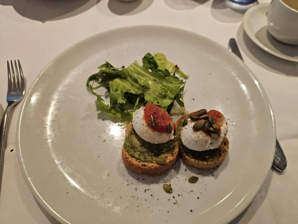 Cruising with Danny and Peter, Holland America Line, Nieuw Statendam, Atlantic Ocean Sea Day Experience | A vibrant collage capturing a sea day on Holland America’s Nieuw Statendam: a panoramic view of the Atlantic Ocean’s deep blue waves under golden sunlight from the ship’s deck; an elegant breakfast of eggs Benedict and coffee in the Main Dining Room with ocean-view windows; a digital iris collage with colorful, galaxy-like patterns created in the Explorations Central lounge; and a lively Cassidy Robertson & Company performance on the World Stage, featuring dancers in vibrant costumes against a futuristic LED backdrop.