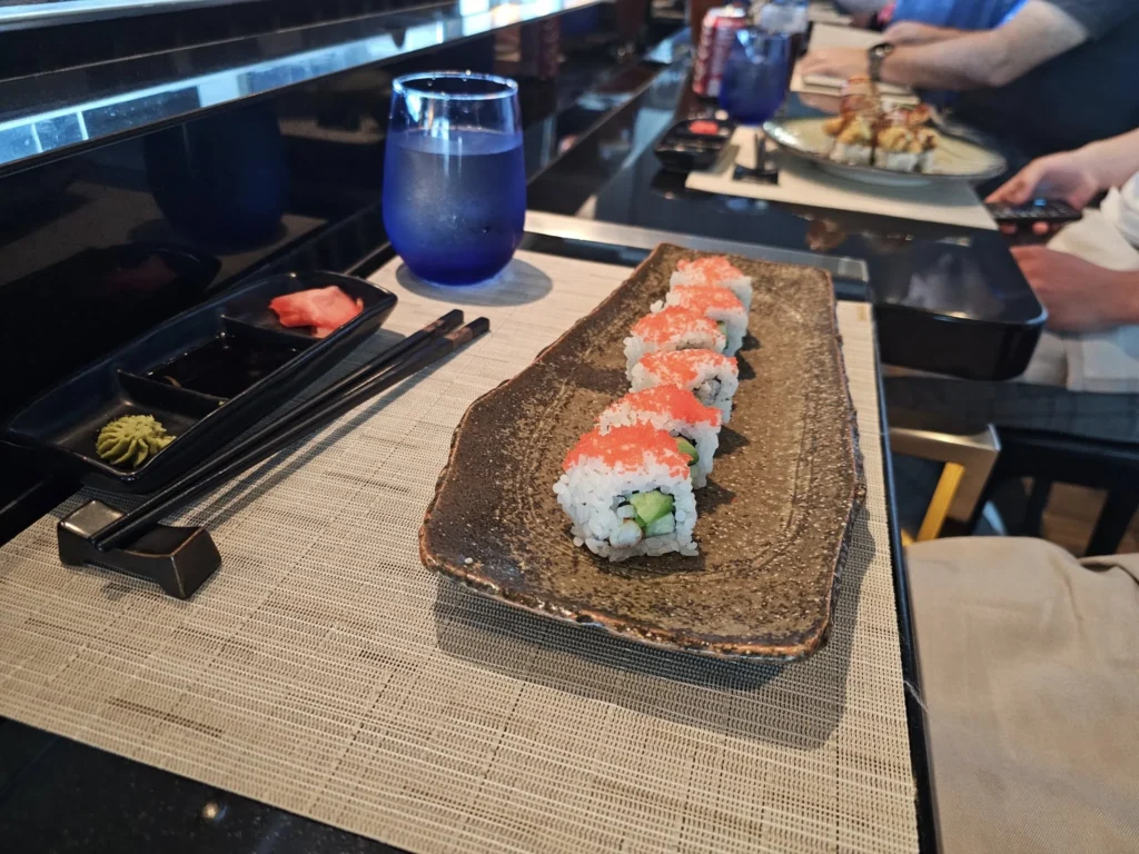 Cruising with Danny and Peter, Holland America Line, Nieuw Statendam, Atlantic Ocean Sea Day Experience | A vibrant collage capturing a sea day on Holland America’s Nieuw Statendam: a panoramic view of the Atlantic Ocean’s deep blue waves under golden sunlight from the ship’s deck; an elegant breakfast of eggs Benedict and coffee in the Main Dining Room with ocean-view windows; a digital iris collage with colorful, galaxy-like patterns created in the Explorations Central lounge; and a lively Cassidy Robertson & Company performance on the World Stage, featuring dancers in vibrant costumes against a futuristic LED backdrop.