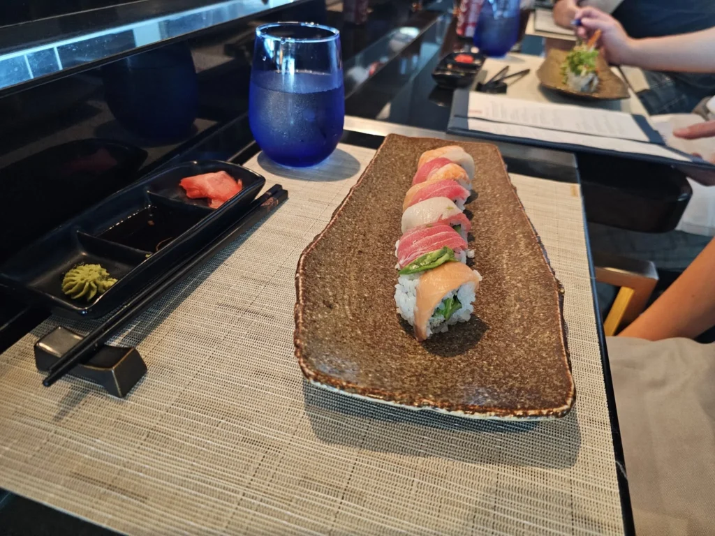 Cruising with Danny and Peter, Holland America Line, Nieuw Statendam, Atlantic Ocean Sea Day Experience | A vibrant collage capturing a sea day on Holland America’s Nieuw Statendam: a panoramic view of the Atlantic Ocean’s deep blue waves under golden sunlight from the ship’s deck; an elegant breakfast of eggs Benedict and coffee in the Main Dining Room with ocean-view windows; a digital iris collage with colorful, galaxy-like patterns created in the Explorations Central lounge; and a lively Cassidy Robertson & Company performance on the World Stage, featuring dancers in vibrant costumes against a futuristic LED backdrop.