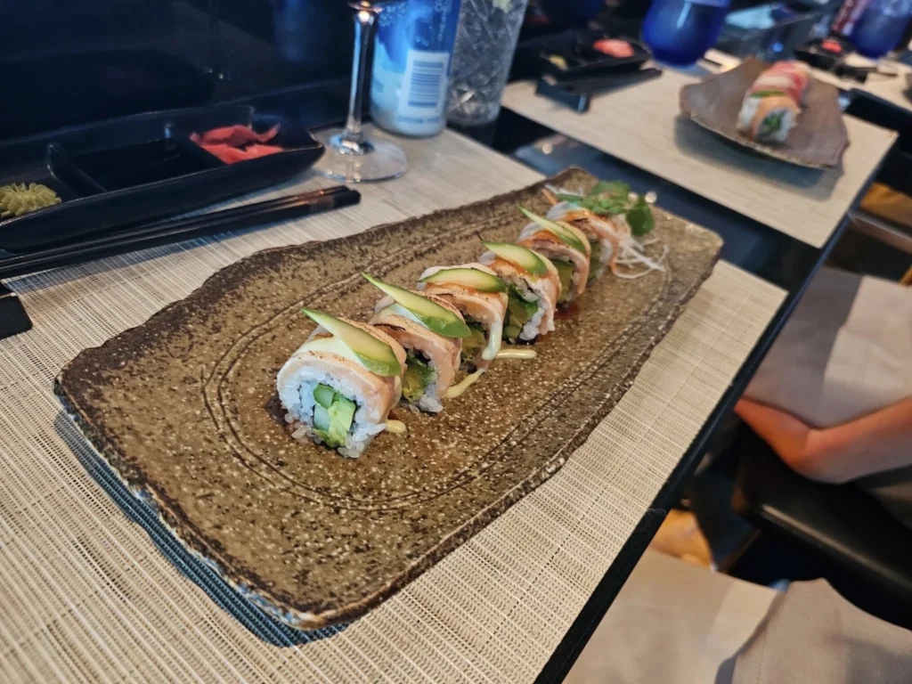 Cruising with Danny and Peter, Holland America Line, Nieuw Statendam, Atlantic Ocean Sea Day Experience | A vibrant collage capturing a sea day on Holland America’s Nieuw Statendam: a panoramic view of the Atlantic Ocean’s deep blue waves under golden sunlight from the ship’s deck; an elegant breakfast of eggs Benedict and coffee in the Main Dining Room with ocean-view windows; a digital iris collage with colorful, galaxy-like patterns created in the Explorations Central lounge; and a lively Cassidy Robertson & Company performance on the World Stage, featuring dancers in vibrant costumes against a futuristic LED backdrop.