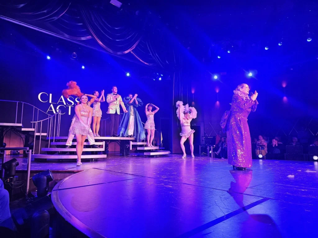 Cruising with Danny and Peter, Holland America Line, Nieuw Statendam, Atlantic Ocean Sea Day Experience | A vibrant collage capturing a sea day on Holland America’s Nieuw Statendam: a panoramic view of the Atlantic Ocean’s deep blue waves under golden sunlight from the ship’s deck; an elegant breakfast of eggs Benedict and coffee in the Main Dining Room with ocean-view windows; a digital iris collage with colorful, galaxy-like patterns created in the Explorations Central lounge; and a lively Cassidy Robertson & Company performance on the World Stage, featuring dancers in vibrant costumes against a futuristic LED backdrop.