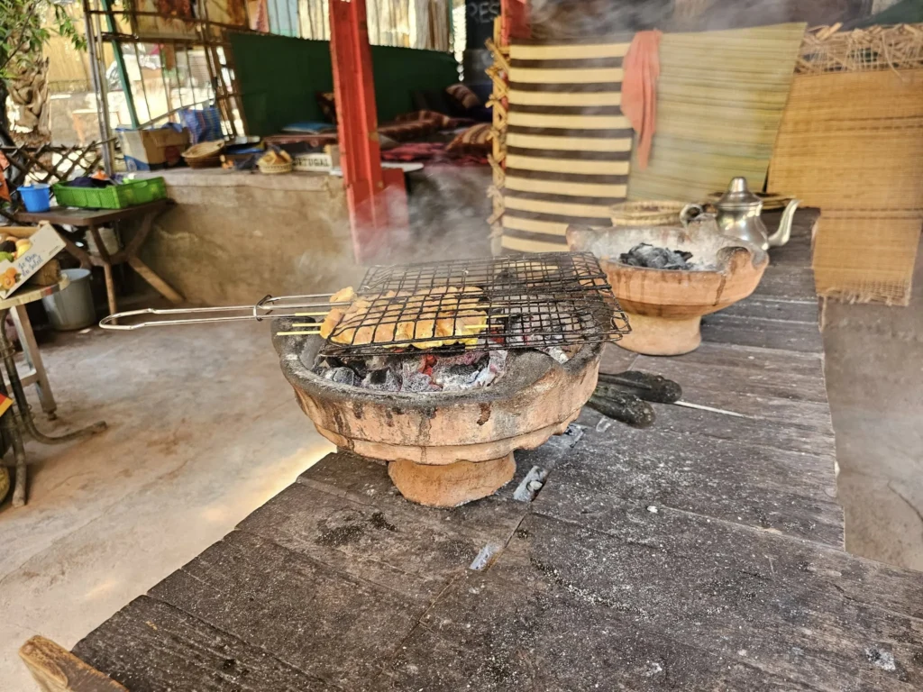 Cruising with Danny and Peter, Holland America Line, Nieuw Statendam, Agadir Morocco Adventure | A vibrant collage capturing a day in Agadir, Morocco, during a Holland America Nieuw Statendam cruise: the white façade and green-tiled minaret of Mosque Mohammed V gleaming under the sun; the bustling Agadir Marina with yachts bobbing in the harbor and golden beach sands stretching toward the Anti-Atlas Mountains; the historic Agadir Oufella kasbah ruins on a hill overlooking the sparkling Atlantic; Sven riding a camel along a scenic path with a Berber handler; the colorful chaos of Souk El Had market with stalls of spices, rugs, and jewelry; the lush Paradise Valley oasis with palm trees, clear pools, and tiny fish nibbling at feet; and an aromatic garden with Moroccan bread, argan oil, and mint tea under a shaded canopy.