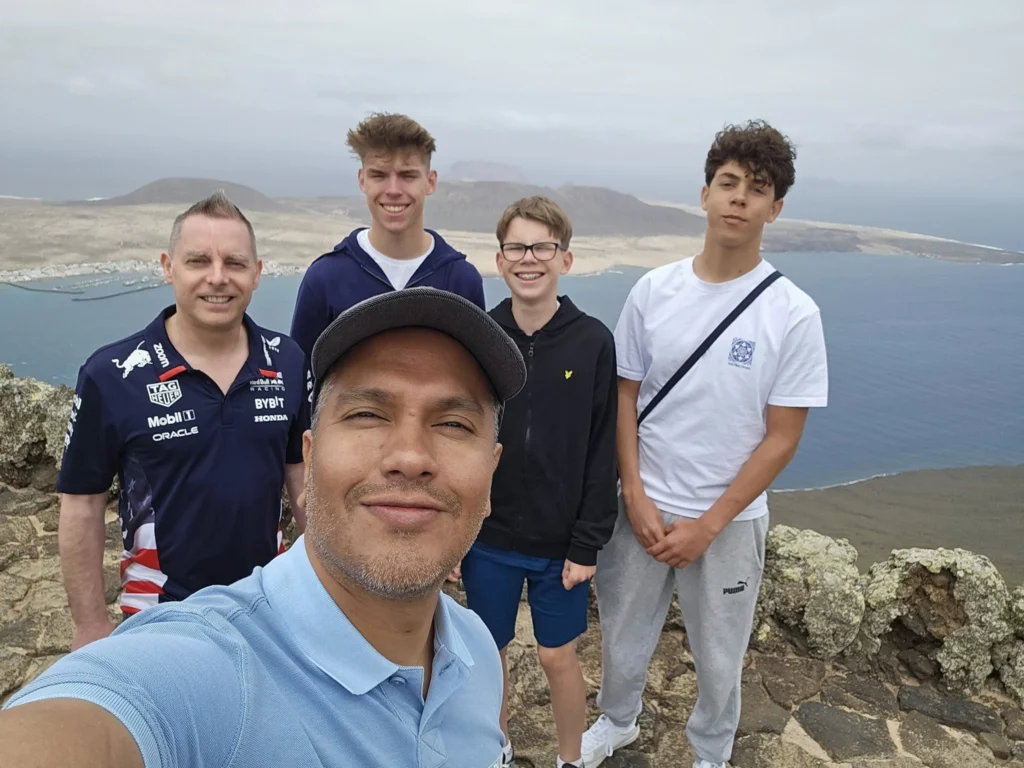 Cruising with Danny and Peter, Holland America Line, Nieuw Statendam, Arrecife, Lanzarote, Canary Islands, Volcanic Adventure | A vibrant collage capturing an adventure in Arrecife, Lanzarote: the dark, winding lava tunnels of Cueva de los Verdes illuminated by soft lights; the serene turquoise pool and lush greenery of Jameos del Agua with its volcanic cave backdrop; the sweeping ocean views from Mirador del Río’s cliffside lookout, framing La Graciosa island; and the surreal, Mars-like red and black lava fields of Timanfaya National Park under a clear sky, showcasing Lanzarote’s volcanic beauty.