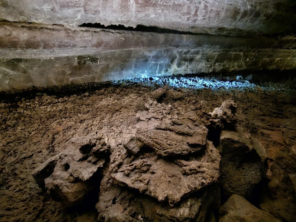 Cruising with Danny and Peter, Holland America Line, Nieuw Statendam, Arrecife, Lanzarote, Canary Islands, Volcanic Adventure | A vibrant collage capturing an adventure in Arrecife, Lanzarote: the dark, winding lava tunnels of Cueva de los Verdes illuminated by soft lights; the serene turquoise pool and lush greenery of Jameos del Agua with its volcanic cave backdrop; the sweeping ocean views from Mirador del Río’s cliffside lookout, framing La Graciosa island; and the surreal, Mars-like red and black lava fields of Timanfaya National Park under a clear sky, showcasing Lanzarote’s volcanic beauty.