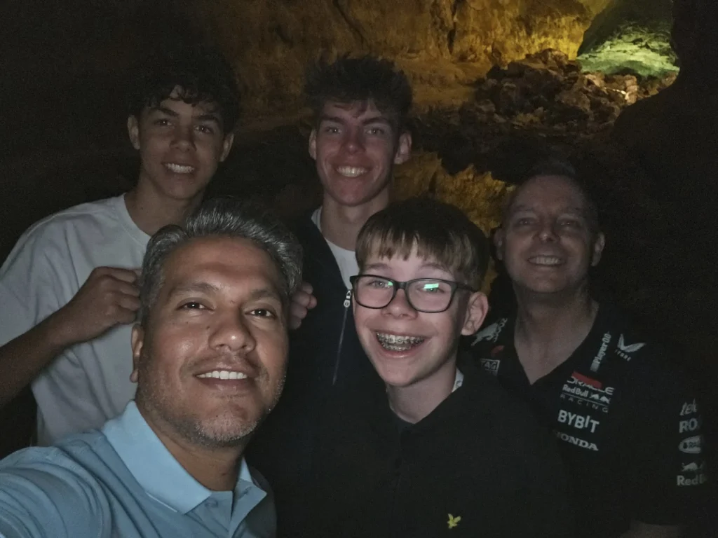 Cruising with Danny and Peter, Holland America Line, Nieuw Statendam, Arrecife, Lanzarote, Canary Islands, Volcanic Adventure | A vibrant collage capturing an adventure in Arrecife, Lanzarote: the dark, winding lava tunnels of Cueva de los Verdes illuminated by soft lights; the serene turquoise pool and lush greenery of Jameos del Agua with its volcanic cave backdrop; the sweeping ocean views from Mirador del Río’s cliffside lookout, framing La Graciosa island; and the surreal, Mars-like red and black lava fields of Timanfaya National Park under a clear sky, showcasing Lanzarote’s volcanic beauty.