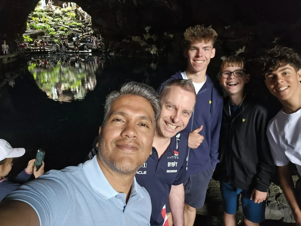 Cruising with Danny and Peter, Holland America Line, Nieuw Statendam, Arrecife, Lanzarote, Canary Islands, Volcanic Adventure | A vibrant collage capturing an adventure in Arrecife, Lanzarote: the dark, winding lava tunnels of Cueva de los Verdes illuminated by soft lights; the serene turquoise pool and lush greenery of Jameos del Agua with its volcanic cave backdrop; the sweeping ocean views from Mirador del Río’s cliffside lookout, framing La Graciosa island; and the surreal, Mars-like red and black lava fields of Timanfaya National Park under a clear sky, showcasing Lanzarote’s volcanic beauty.