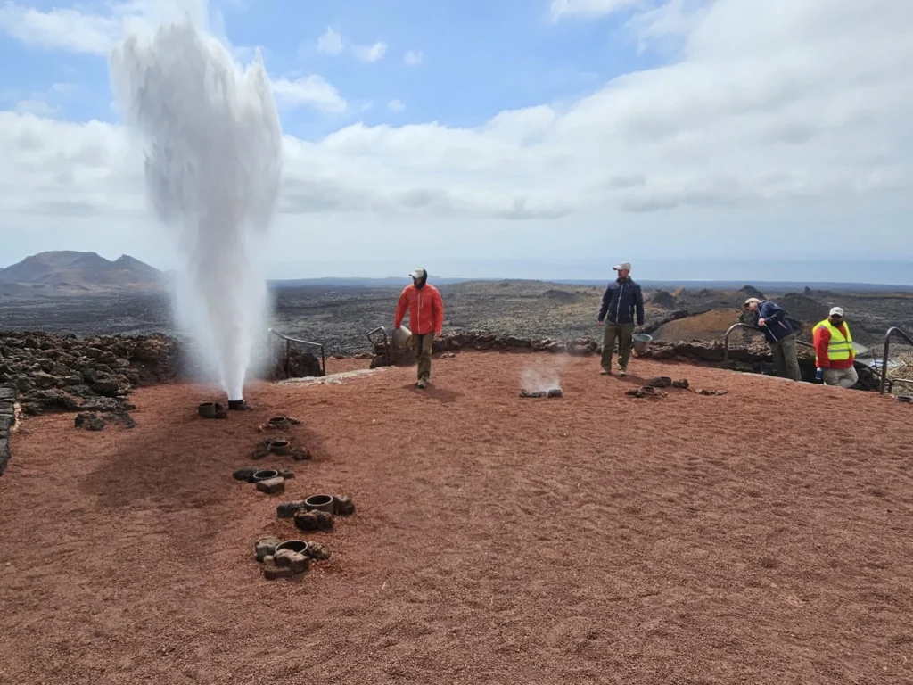 Cruising with Danny and Peter, Holland America Line, Nieuw Statendam, Arrecife, Lanzarote, Canary Islands, Volcanic Adventure | A vibrant collage capturing an adventure in Arrecife, Lanzarote: the dark, winding lava tunnels of Cueva de los Verdes illuminated by soft lights; the serene turquoise pool and lush greenery of Jameos del Agua with its volcanic cave backdrop; the sweeping ocean views from Mirador del Río’s cliffside lookout, framing La Graciosa island; and the surreal, Mars-like red and black lava fields of Timanfaya National Park under a clear sky, showcasing Lanzarote’s volcanic beauty.