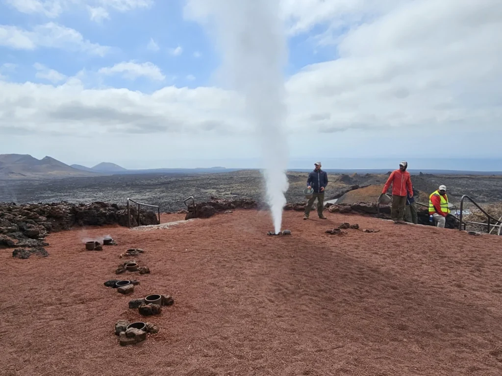 Cruising with Danny and Peter, Holland America Line, Nieuw Statendam, Arrecife, Lanzarote, Canary Islands, Volcanic Adventure | A vibrant collage capturing an adventure in Arrecife, Lanzarote: the dark, winding lava tunnels of Cueva de los Verdes illuminated by soft lights; the serene turquoise pool and lush greenery of Jameos del Agua with its volcanic cave backdrop; the sweeping ocean views from Mirador del Río’s cliffside lookout, framing La Graciosa island; and the surreal, Mars-like red and black lava fields of Timanfaya National Park under a clear sky, showcasing Lanzarote’s volcanic beauty.