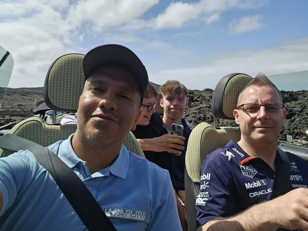 Cruising with Danny and Peter, Holland America Line, Nieuw Statendam, Arrecife, Lanzarote, Canary Islands, Volcanic Adventure | A vibrant collage capturing an adventure in Arrecife, Lanzarote: the dark, winding lava tunnels of Cueva de los Verdes illuminated by soft lights; the serene turquoise pool and lush greenery of Jameos del Agua with its volcanic cave backdrop; the sweeping ocean views from Mirador del Río’s cliffside lookout, framing La Graciosa island; and the surreal, Mars-like red and black lava fields of Timanfaya National Park under a clear sky, showcasing Lanzarote’s volcanic beauty.