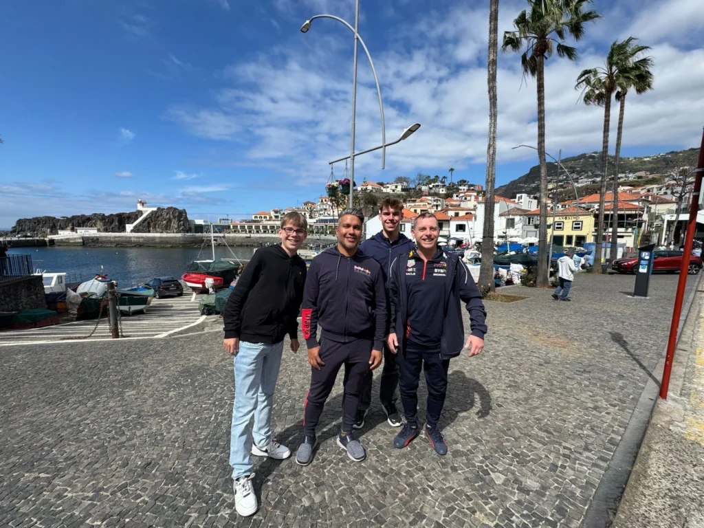Cruising with Danny and Peter, Holland America Line, Nieuw Statendam, Funchal, Madeira. Portugal, History Adventure | A vibrant collage capturing a day in Funchal, Madeira: a sleek trike navigates winding roads with lush green hills in the background; the panoramic view from Pico dos Barcelos showcases Funchal Bay and the Desertas Islands under a clear sky; Cascata dos Anjos waterfall cascades from cliffs onto a road, surrounded by verdant greenery; Praia da Madalena do Mar’s pebbled beach and black volcanic sand meet gentle waves with towering cliffs above; the misty Valley of the Nuns nestles between rugged mountains, dotted with stone houses and chestnut groves; Cabo Girão’s glass-bottomed skywalk reveals a dizzying drop to the Atlantic and terraced fields below; a plate of warm bolo do caco flatbread filled with steak sits on a café table in Funchal’s colorful old town; the CR7 Museum displays Cristiano Ronaldo’s trophies and jerseys with a waterfront view of the Nieuw Statendam; and Nami Sushi Bar’s elegant sushi platter gleams under soft lighting aboard the ship.
