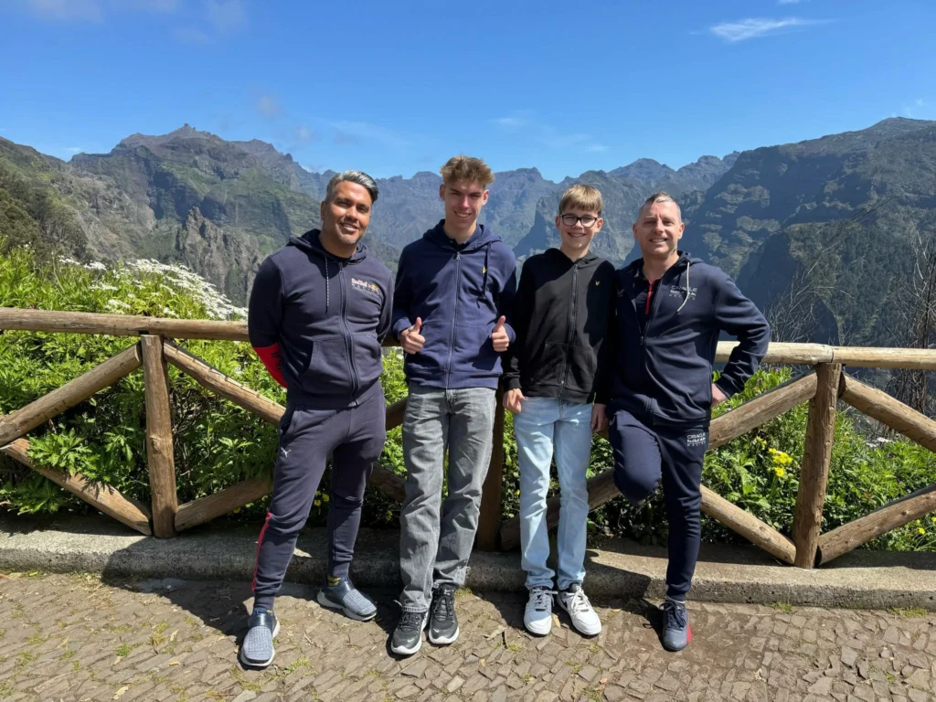 Cruising with Danny and Peter, Holland America Line, Nieuw Statendam, Funchal, Madeira. Portugal, History Adventure | A vibrant collage capturing a day in Funchal, Madeira: a sleek trike navigates winding roads with lush green hills in the background; the panoramic view from Pico dos Barcelos showcases Funchal Bay and the Desertas Islands under a clear sky; Cascata dos Anjos waterfall cascades from cliffs onto a road, surrounded by verdant greenery; Praia da Madalena do Mar’s pebbled beach and black volcanic sand meet gentle waves with towering cliffs above; the misty Valley of the Nuns nestles between rugged mountains, dotted with stone houses and chestnut groves; Cabo Girão’s glass-bottomed skywalk reveals a dizzying drop to the Atlantic and terraced fields below; a plate of warm bolo do caco flatbread filled with steak sits on a café table in Funchal’s colorful old town; the CR7 Museum displays Cristiano Ronaldo’s trophies and jerseys with a waterfront view of the Nieuw Statendam; and Nami Sushi Bar’s elegant sushi platter gleams under soft lighting aboard the ship.
