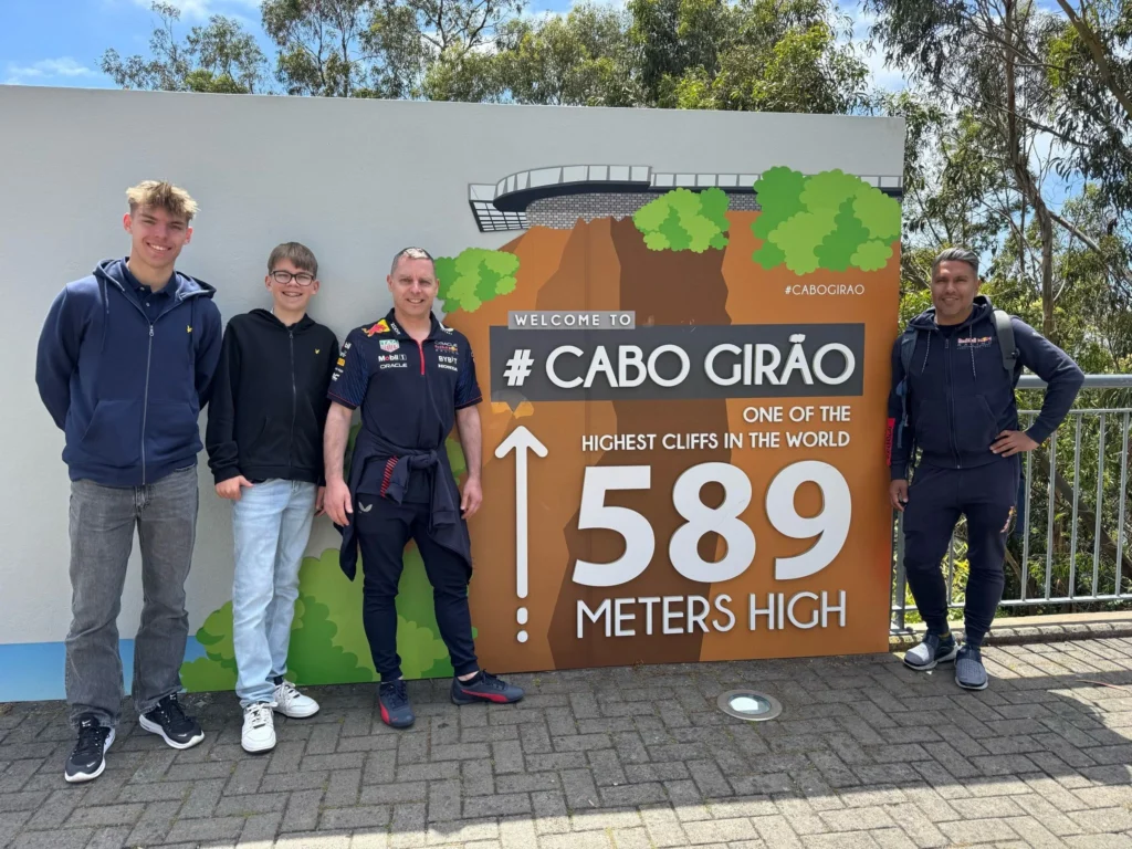 Cruising with Danny and Peter, Holland America Line, Nieuw Statendam, Funchal, Madeira. Portugal, History Adventure | A vibrant collage capturing a day in Funchal, Madeira: a sleek trike navigates winding roads with lush green hills in the background; the panoramic view from Pico dos Barcelos showcases Funchal Bay and the Desertas Islands under a clear sky; Cascata dos Anjos waterfall cascades from cliffs onto a road, surrounded by verdant greenery; Praia da Madalena do Mar’s pebbled beach and black volcanic sand meet gentle waves with towering cliffs above; the misty Valley of the Nuns nestles between rugged mountains, dotted with stone houses and chestnut groves; Cabo Girão’s glass-bottomed skywalk reveals a dizzying drop to the Atlantic and terraced fields below; a plate of warm bolo do caco flatbread filled with steak sits on a café table in Funchal’s colorful old town; the CR7 Museum displays Cristiano Ronaldo’s trophies and jerseys with a waterfront view of the Nieuw Statendam; and Nami Sushi Bar’s elegant sushi platter gleams under soft lighting aboard the ship.
