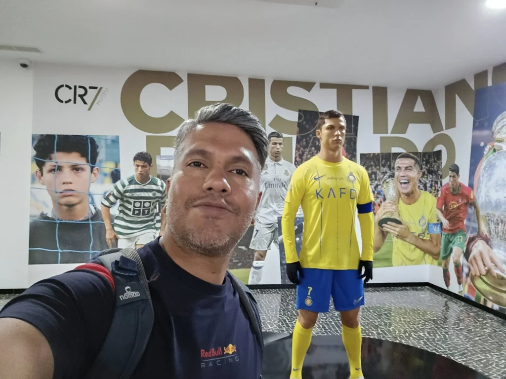 Cruising with Danny and Peter, Holland America Line, Nieuw Statendam, Funchal, Madeira. Portugal, History Adventure | A vibrant collage capturing a day in Funchal, Madeira: a sleek trike navigates winding roads with lush green hills in the background; the panoramic view from Pico dos Barcelos showcases Funchal Bay and the Desertas Islands under a clear sky; Cascata dos Anjos waterfall cascades from cliffs onto a road, surrounded by verdant greenery; Praia da Madalena do Mar’s pebbled beach and black volcanic sand meet gentle waves with towering cliffs above; the misty Valley of the Nuns nestles between rugged mountains, dotted with stone houses and chestnut groves; Cabo Girão’s glass-bottomed skywalk reveals a dizzying drop to the Atlantic and terraced fields below; a plate of warm bolo do caco flatbread filled with steak sits on a café table in Funchal’s colorful old town; the CR7 Museum displays Cristiano Ronaldo’s trophies and jerseys with a waterfront view of the Nieuw Statendam; and Nami Sushi Bar’s elegant sushi platter gleams under soft lighting aboard the ship.