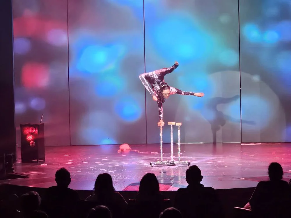 Cruising with Danny and Peter, Holland America Line, Nieuw Statendam, Funchal, Madeira. Portugal, History Adventure | A vibrant collage capturing a day in Funchal, Madeira: a sleek trike navigates winding roads with lush green hills in the background; the panoramic view from Pico dos Barcelos showcases Funchal Bay and the Desertas Islands under a clear sky; Cascata dos Anjos waterfall cascades from cliffs onto a road, surrounded by verdant greenery; Praia da Madalena do Mar’s pebbled beach and black volcanic sand meet gentle waves with towering cliffs above; the misty Valley of the Nuns nestles between rugged mountains, dotted with stone houses and chestnut groves; Cabo Girão’s glass-bottomed skywalk reveals a dizzying drop to the Atlantic and terraced fields below; a plate of warm bolo do caco flatbread filled with steak sits on a café table in Funchal’s colorful old town; the CR7 Museum displays Cristiano Ronaldo’s trophies and jerseys with a waterfront view of the Nieuw Statendam; and Nami Sushi Bar’s elegant sushi platter gleams under soft lighting aboard the ship.