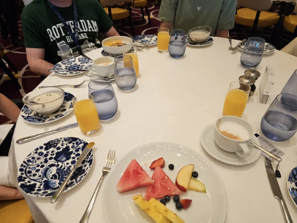 Cruising with Danny and Peter, Holland America Line, Nieuw Statendam, Atlantic Ocean, Sea Day, Adventure | A family savors a Nieuw Statendam Sea Day, enjoying a breakfast of cheesy omelets in the elegant main dining room, indulging in sushi rolls at the vibrant Lido Market, and feasting on a seafood boil with crab legs under starlit skies. The Atlantic Ocean sparkles outside, enhancing Holland America’s luxurious cruise experience with gourmet dining and relaxation.