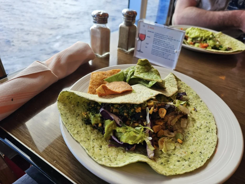 Cruising with Danny and Peter, Holland America Line, Nieuw Statendam, Atlantic Ocean, Sea Day, Adventure | A family savors a Nieuw Statendam Sea Day, enjoying a breakfast of cheesy omelets in the elegant main dining room, indulging in sushi rolls at the vibrant Lido Market, and feasting on a seafood boil with crab legs under starlit skies. The Atlantic Ocean sparkles outside, enhancing Holland America’s luxurious cruise experience with gourmet dining and relaxation.