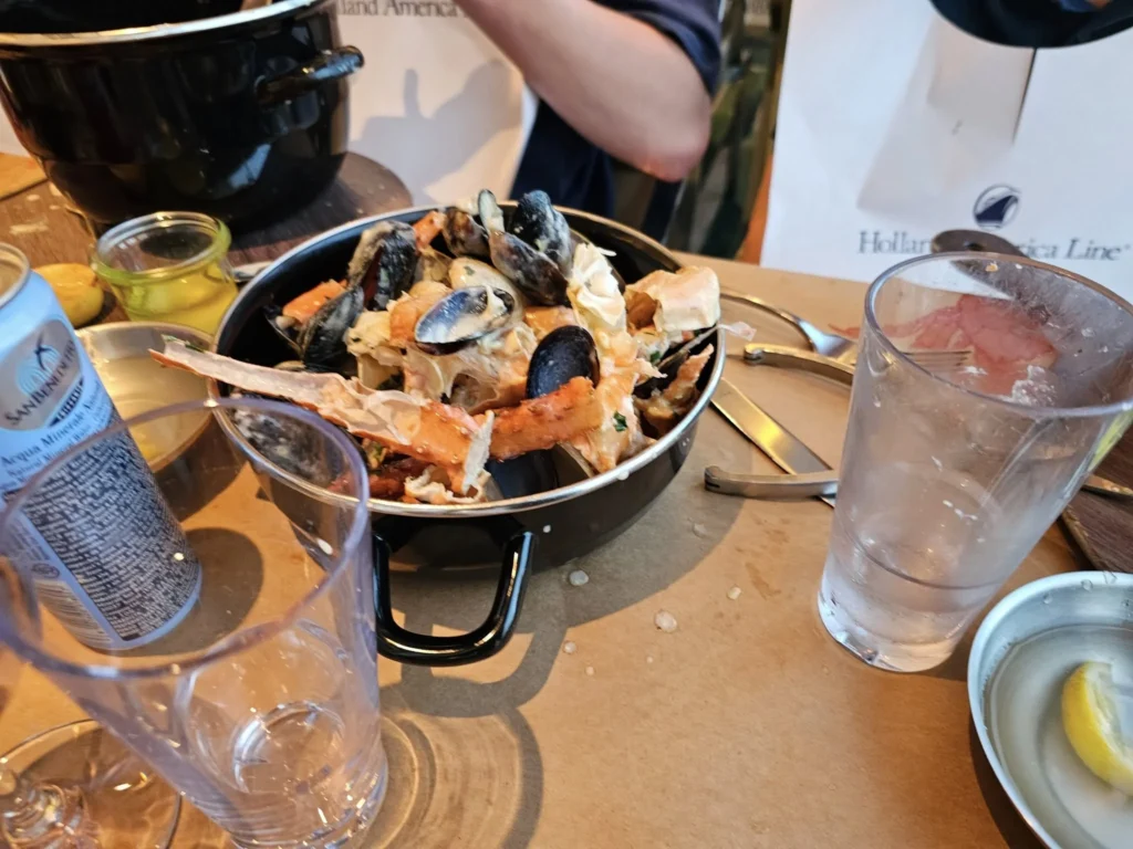 Cruising with Danny and Peter, Holland America Line, Nieuw Statendam, Atlantic Ocean, Sea Day, Adventure | A family savors a Nieuw Statendam Sea Day, enjoying a breakfast of cheesy omelets in the elegant main dining room, indulging in sushi rolls at the vibrant Lido Market, and feasting on a seafood boil with crab legs under starlit skies. The Atlantic Ocean sparkles outside, enhancing Holland America’s luxurious cruise experience with gourmet dining and relaxation.