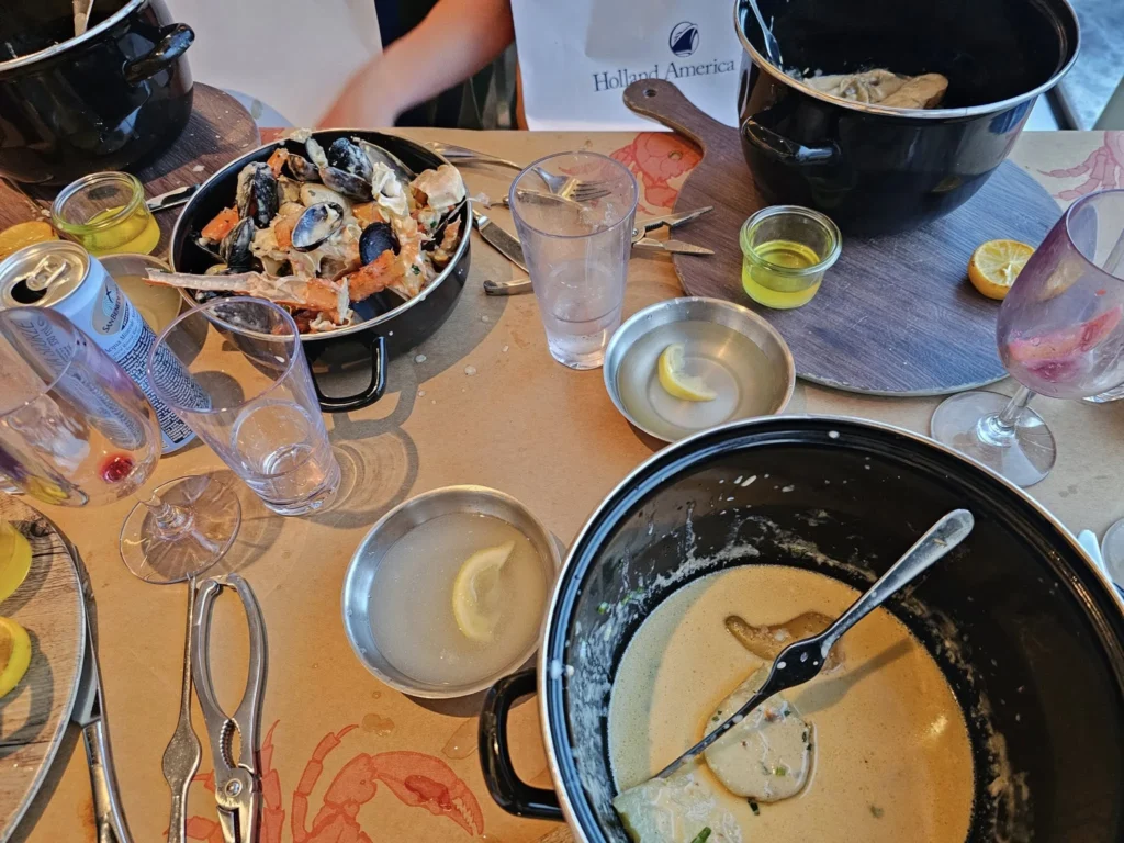 Cruising with Danny and Peter, Holland America Line, Nieuw Statendam, Atlantic Ocean, Sea Day, Adventure | A family savors a Nieuw Statendam Sea Day, enjoying a breakfast of cheesy omelets in the elegant main dining room, indulging in sushi rolls at the vibrant Lido Market, and feasting on a seafood boil with crab legs under starlit skies. The Atlantic Ocean sparkles outside, enhancing Holland America’s luxurious cruise experience with gourmet dining and relaxation.