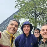 Cruising with Danny and Peter, Holland America Line, Nieuw Statendam, Leixoes, Porto, Portugal, Rainy Adventure | A vibrant collage capturing a rainy day adventure in Porto, Portugal, from the Holland America Line’s Nieuw Statendam cruise. The scene includes a colorful tuk-tuk navigating Porto’s wet, cobblestone streets with historic buildings in the background, the iconic Dom Luís I Bridge spanning the Douro River under gray skies, the majestic Porto Cathedral with its Gothic facade glistening in the rain, and the intricate blue-and-white azulejo tiles of São Bento Station’s atrium. Onboard, a beautifully plated dish from Tamarind restaurant showcases exotic flavors, while the lively Lido Fun Fair on the Lido Midship deck features children enjoying carnival games under a retractable roof, with colorful decorations and cotton candy adding festive cheer.