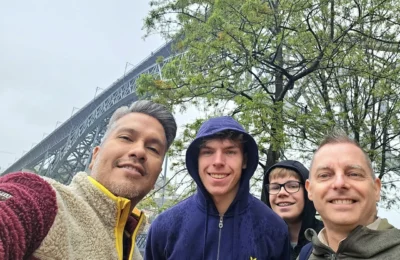 Cruising with Danny and Peter, Holland America Line, Nieuw Statendam, Leixoes, Porto, Portugal, Rainy Adventure | A vibrant collage capturing a rainy day adventure in Porto, Portugal, from the Holland America Line’s Nieuw Statendam cruise. The scene includes a colorful tuk-tuk navigating Porto’s wet, cobblestone streets with historic buildings in the background, the iconic Dom Luís I Bridge spanning the Douro River under gray skies, the majestic Porto Cathedral with its Gothic facade glistening in the rain, and the intricate blue-and-white azulejo tiles of São Bento Station’s atrium. Onboard, a beautifully plated dish from Tamarind restaurant showcases exotic flavors, while the lively Lido Fun Fair on the Lido Midship deck features children enjoying carnival games under a retractable roof, with colorful decorations and cotton candy adding festive cheer.