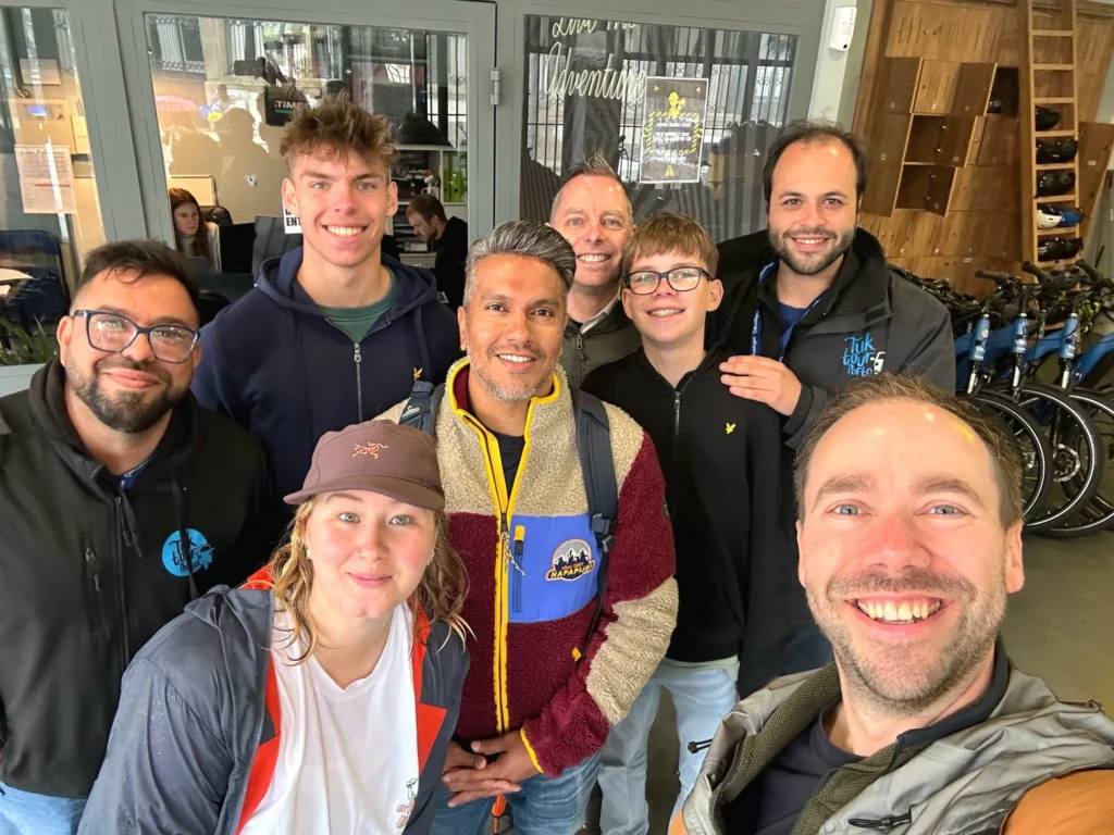 Cruising with Danny and Peter, Holland America Line, Nieuw Statendam, Leixoes, Porto, Portugal, Rainy Adventure | A vibrant collage capturing a rainy day adventure in Porto, Portugal, from the Holland America Line’s Nieuw Statendam cruise. The scene includes a colorful tuk-tuk navigating Porto’s wet, cobblestone streets with historic buildings in the background, the iconic Dom Luís I Bridge spanning the Douro River under gray skies, the majestic Porto Cathedral with its Gothic facade glistening in the rain, and the intricate blue-and-white azulejo tiles of São Bento Station’s atrium. Onboard, a beautifully plated dish from Tamarind restaurant showcases exotic flavors, while the lively Lido Fun Fair on the Lido Midship deck features children enjoying carnival games under a retractable roof, with colorful decorations and cotton candy adding festive cheer.