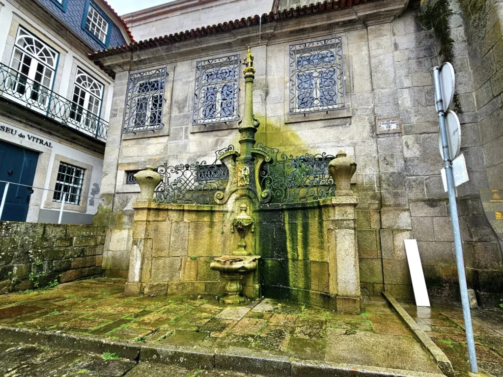 Cruising with Danny and Peter, Holland America Line, Nieuw Statendam, Leixoes, Porto, Portugal, Rainy Adventure | A vibrant collage capturing a rainy day adventure in Porto, Portugal, from the Holland America Line’s Nieuw Statendam cruise. The scene includes a colorful tuk-tuk navigating Porto’s wet, cobblestone streets with historic buildings in the background, the iconic Dom Luís I Bridge spanning the Douro River under gray skies, the majestic Porto Cathedral with its Gothic facade glistening in the rain, and the intricate blue-and-white azulejo tiles of São Bento Station’s atrium. Onboard, a beautifully plated dish from Tamarind restaurant showcases exotic flavors, while the lively Lido Fun Fair on the Lido Midship deck features children enjoying carnival games under a retractable roof, with colorful decorations and cotton candy adding festive cheer.