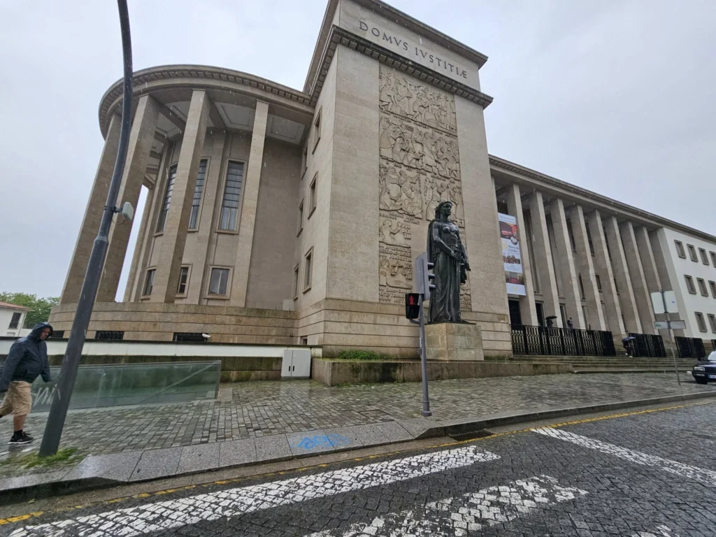 Cruising with Danny and Peter, Holland America Line, Nieuw Statendam, Leixoes, Porto, Portugal, Rainy Adventure | A vibrant collage capturing a rainy day adventure in Porto, Portugal, from the Holland America Line’s Nieuw Statendam cruise. The scene includes a colorful tuk-tuk navigating Porto’s wet, cobblestone streets with historic buildings in the background, the iconic Dom Luís I Bridge spanning the Douro River under gray skies, the majestic Porto Cathedral with its Gothic facade glistening in the rain, and the intricate blue-and-white azulejo tiles of São Bento Station’s atrium. Onboard, a beautifully plated dish from Tamarind restaurant showcases exotic flavors, while the lively Lido Fun Fair on the Lido Midship deck features children enjoying carnival games under a retractable roof, with colorful decorations and cotton candy adding festive cheer.