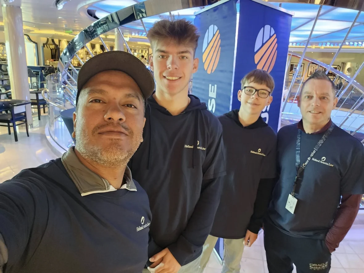 Cruising with Danny and Peter, Holland America Line, Nieuw Statendam, Biscay Bliss Sea Day | A vibrant collage capturing a sea day aboard Holland America Line’s Nieuw Statendam in the Bay of Biscay. The scene includes a pod of dolphins leaping gracefully through shimmering blue waves alongside the ship, their sleek bodies catching the sunlight. Passengers walk energetically on the sunlit deck during a charity event, with the vast ocean horizon stretching behind them. The elegant interior of Rudi’s Sel de Mer restaurant features a beautifully set table with a plate of seared scallops and a chocolate soufflé, illuminated by warm lighting. The World Stage theater glows with a large LED screen displaying Dover’s white cliffs, as the audience listens attentively to a port talk. A couple poses for a photoshoot on deck at sunset, framed by the golden glow of the Bay of Biscay’s horizon, with the ship’s sleek railings in the foreground.