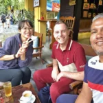 Cruising with Danny and Peter, Holland America Line, Westerdam, Da Nang, Hue, Hoi An, Vietnam, Hoi An Travel Guide: 10 Unmissable Adventures | Collage of a Hội An Travel Guide adventure: Tourists enjoying a Basket Boat Ride through Cam Thanh Eco-Village’s lush waterways, local farmers tending organic herbs at Tra Que Village showcasing Vietnamese Culture, the historic Japanese Bridge in Hội An Old Town, a close-up of creamy Egg Coffee from Vietnamese Cuisine, vibrant Lantern-Lit Streets glowing at night, and a scenic view from a Da Nang Day Trip to kick off this unforgettable journey.