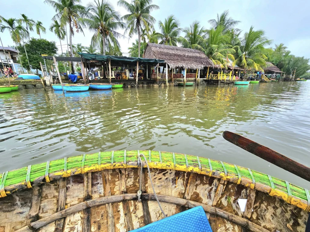 Cruising with Danny and Peter, Holland America Line, Westerdam, Da Nang, Hue, Hoi An, Vietnam, Hoi An Travel Guide: 10 Unmissable Adventures | Collage of a Hội An Travel Guide adventure: Tourists enjoying a Basket Boat Ride through Cam Thanh Eco-Village’s lush waterways, local farmers tending organic herbs at Tra Que Village showcasing Vietnamese Culture, the historic Japanese Bridge in Hội An Old Town, a close-up of creamy Egg Coffee from Vietnamese Cuisine, vibrant Lantern-Lit Streets glowing at night, and a scenic view from a Da Nang Day Trip to kick off this unforgettable journey.