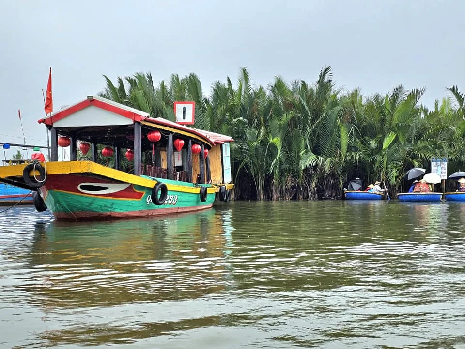 Cruising with Danny and Peter, Holland America Line, Westerdam, Da Nang, Hue, Hoi An, Vietnam, Hoi An Travel Guide: 10 Unmissable Adventures | Collage of a Hội An Travel Guide adventure: Tourists enjoying a Basket Boat Ride through Cam Thanh Eco-Village’s lush waterways, local farmers tending organic herbs at Tra Que Village showcasing Vietnamese Culture, the historic Japanese Bridge in Hội An Old Town, a close-up of creamy Egg Coffee from Vietnamese Cuisine, vibrant Lantern-Lit Streets glowing at night, and a scenic view from a Da Nang Day Trip to kick off this unforgettable journey.