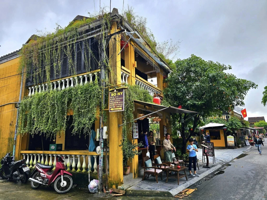 Cruising with Danny and Peter, Holland America Line, Westerdam, Da Nang, Hue, Hoi An, Vietnam, Hoi An Travel Guide: 10 Unmissable Adventures | Collage of a Hội An Travel Guide adventure: Tourists enjoying a Basket Boat Ride through Cam Thanh Eco-Village’s lush waterways, local farmers tending organic herbs at Tra Que Village showcasing Vietnamese Culture, the historic Japanese Bridge in Hội An Old Town, a close-up of creamy Egg Coffee from Vietnamese Cuisine, vibrant Lantern-Lit Streets glowing at night, and a scenic view from a Da Nang Day Trip to kick off this unforgettable journey.
