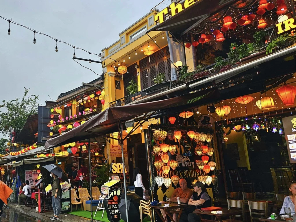 Cruising with Danny and Peter, Holland America Line, Westerdam, Da Nang, Hue, Hoi An, Vietnam, Hoi An Travel Guide: 10 Unmissable Adventures | Collage of a Hội An Travel Guide adventure: Tourists enjoying a Basket Boat Ride through Cam Thanh Eco-Village’s lush waterways, local farmers tending organic herbs at Tra Que Village showcasing Vietnamese Culture, the historic Japanese Bridge in Hội An Old Town, a close-up of creamy Egg Coffee from Vietnamese Cuisine, vibrant Lantern-Lit Streets glowing at night, and a scenic view from a Da Nang Day Trip to kick off this unforgettable journey.
