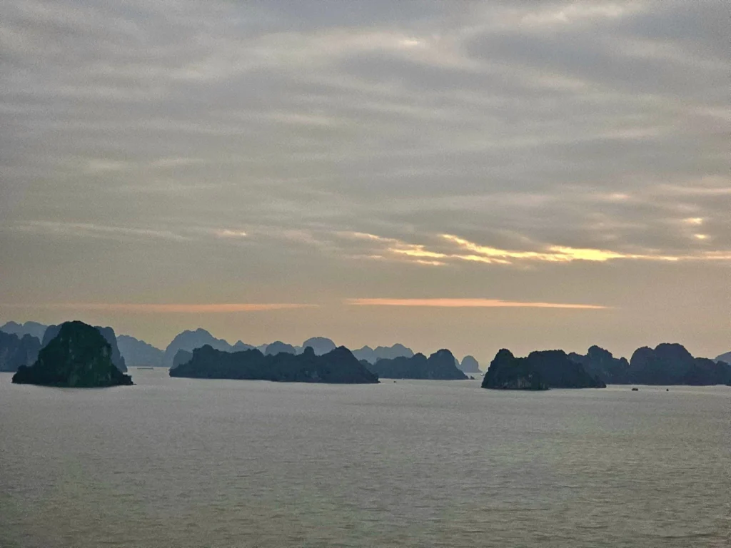 Cruising with Danny and Peter, Holland America Line, Westerdam, Halong Bay, Hanoi, Vietnam, Vietnam Travel Eexperience Hanoi Halong Bay | Kayaking through emerald waters during a Hạ Long Bay Adventure with limestone karsts, a train passing inches from cafés on Hanoi Railway Street showcasing Hanoi Street Life, the granite Ho Chi Minh Mausoleum in Ba Dinh Square honoring the Ho Chi Minh Legacy, the lotus-shaped One Pillar Pagoda in a pond among Hanoi Historical Sites, ancient courtyards of the Temple of Literature from a Vietnam Heritage Journey, vibrant street food stalls in an Old Quarter Food Tour, and creamy egg coffee at Cafe Giảng for an Egg Coffee Experience, all part of an unforgettable Vietnam Travel Experience and Hanoi Cultural Exploration Tour.