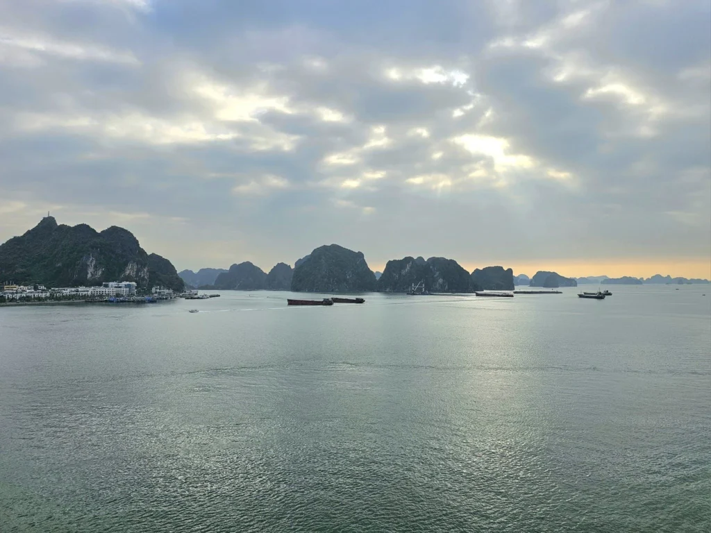 Cruising with Danny and Peter, Holland America Line, Westerdam, Halong Bay, Hanoi, Vietnam, Vietnam Travel Eexperience Hanoi Halong Bay | Kayaking through emerald waters during a Hạ Long Bay Adventure with limestone karsts, a train passing inches from cafés on Hanoi Railway Street showcasing Hanoi Street Life, the granite Ho Chi Minh Mausoleum in Ba Dinh Square honoring the Ho Chi Minh Legacy, the lotus-shaped One Pillar Pagoda in a pond among Hanoi Historical Sites, ancient courtyards of the Temple of Literature from a Vietnam Heritage Journey, vibrant street food stalls in an Old Quarter Food Tour, and creamy egg coffee at Cafe Giảng for an Egg Coffee Experience, all part of an unforgettable Vietnam Travel Experience and Hanoi Cultural Exploration Tour.