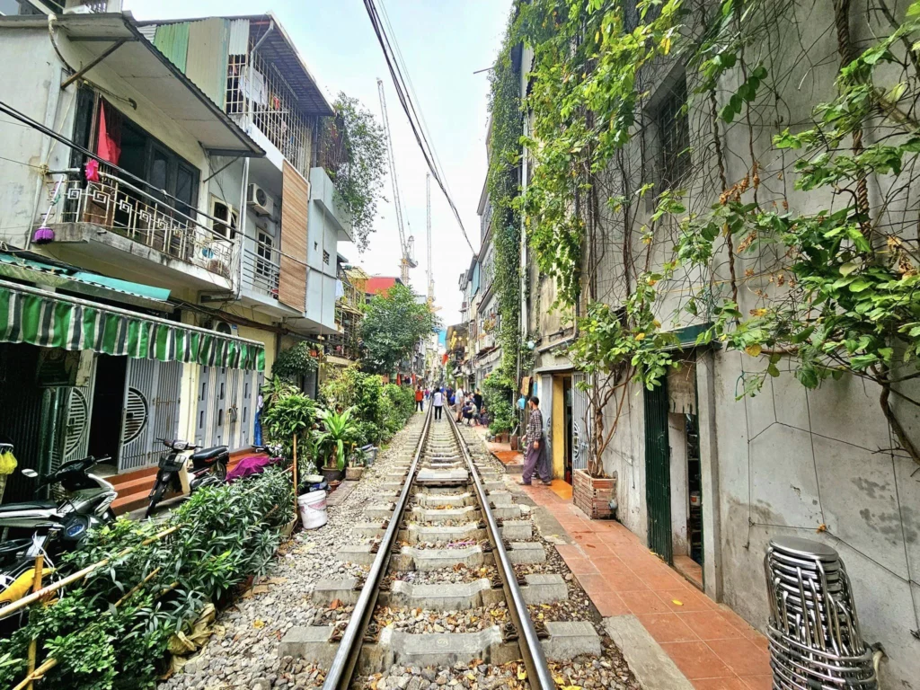 Cruising with Danny and Peter, Holland America Line, Westerdam, Halong Bay, Hanoi, Vietnam, Vietnam Travel Eexperience Hanoi Halong Bay | Kayaking through emerald waters during a Hạ Long Bay Adventure with limestone karsts, a train passing inches from cafés on Hanoi Railway Street showcasing Hanoi Street Life, the granite Ho Chi Minh Mausoleum in Ba Dinh Square honoring the Ho Chi Minh Legacy, the lotus-shaped One Pillar Pagoda in a pond among Hanoi Historical Sites, ancient courtyards of the Temple of Literature from a Vietnam Heritage Journey, vibrant street food stalls in an Old Quarter Food Tour, and creamy egg coffee at Cafe Giảng for an Egg Coffee Experience, all part of an unforgettable Vietnam Travel Experience and Hanoi Cultural Exploration Tour.