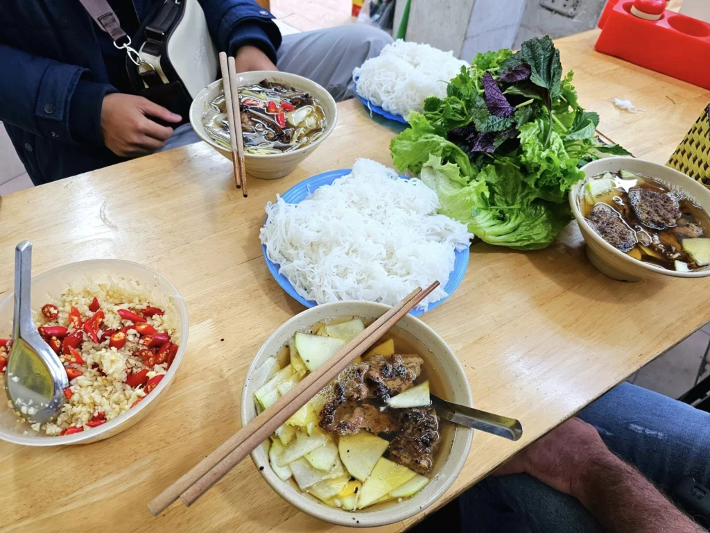 Cruising with Danny and Peter, Holland America Line, Westerdam, Halong Bay, Hanoi, Vietnam, Vietnam Travel Eexperience Hanoi Halong Bay | Kayaking through emerald waters during a Hạ Long Bay Adventure with limestone karsts, a train passing inches from cafés on Hanoi Railway Street showcasing Hanoi Street Life, the granite Ho Chi Minh Mausoleum in Ba Dinh Square honoring the Ho Chi Minh Legacy, the lotus-shaped One Pillar Pagoda in a pond among Hanoi Historical Sites, ancient courtyards of the Temple of Literature from a Vietnam Heritage Journey, vibrant street food stalls in an Old Quarter Food Tour, and creamy egg coffee at Cafe Giảng for an Egg Coffee Experience, all part of an unforgettable Vietnam Travel Experience and Hanoi Cultural Exploration Tour.