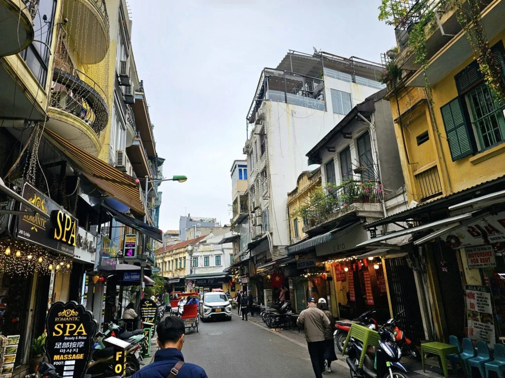 Cruising with Danny and Peter, Holland America Line, Westerdam, Halong Bay, Hanoi, Vietnam, Vietnam Travel Eexperience Hanoi Halong Bay | Kayaking through emerald waters during a Hạ Long Bay Adventure with limestone karsts, a train passing inches from cafés on Hanoi Railway Street showcasing Hanoi Street Life, the granite Ho Chi Minh Mausoleum in Ba Dinh Square honoring the Ho Chi Minh Legacy, the lotus-shaped One Pillar Pagoda in a pond among Hanoi Historical Sites, ancient courtyards of the Temple of Literature from a Vietnam Heritage Journey, vibrant street food stalls in an Old Quarter Food Tour, and creamy egg coffee at Cafe Giảng for an Egg Coffee Experience, all part of an unforgettable Vietnam Travel Experience and Hanoi Cultural Exploration Tour.