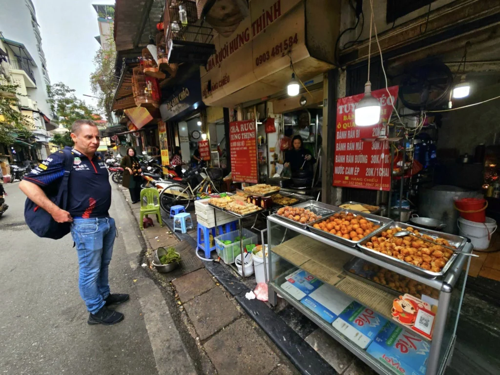 Cruising with Danny and Peter, Holland America Line, Westerdam, Halong Bay, Hanoi, Vietnam, Vietnam Travel Eexperience Hanoi Halong Bay | Kayaking through emerald waters during a Hạ Long Bay Adventure with limestone karsts, a train passing inches from cafés on Hanoi Railway Street showcasing Hanoi Street Life, the granite Ho Chi Minh Mausoleum in Ba Dinh Square honoring the Ho Chi Minh Legacy, the lotus-shaped One Pillar Pagoda in a pond among Hanoi Historical Sites, ancient courtyards of the Temple of Literature from a Vietnam Heritage Journey, vibrant street food stalls in an Old Quarter Food Tour, and creamy egg coffee at Cafe Giảng for an Egg Coffee Experience, all part of an unforgettable Vietnam Travel Experience and Hanoi Cultural Exploration Tour.