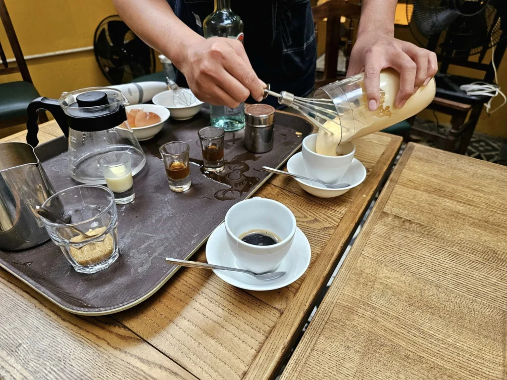 Cruising with Danny and Peter, Holland America Line, Westerdam, Halong Bay, Hanoi, Vietnam, Vietnam Travel Eexperience Hanoi Halong Bay | Kayaking through emerald waters during a Hạ Long Bay Adventure with limestone karsts, a train passing inches from cafés on Hanoi Railway Street showcasing Hanoi Street Life, the granite Ho Chi Minh Mausoleum in Ba Dinh Square honoring the Ho Chi Minh Legacy, the lotus-shaped One Pillar Pagoda in a pond among Hanoi Historical Sites, ancient courtyards of the Temple of Literature from a Vietnam Heritage Journey, vibrant street food stalls in an Old Quarter Food Tour, and creamy egg coffee at Cafe Giảng for an Egg Coffee Experience, all part of an unforgettable Vietnam Travel Experience and Hanoi Cultural Exploration Tour.