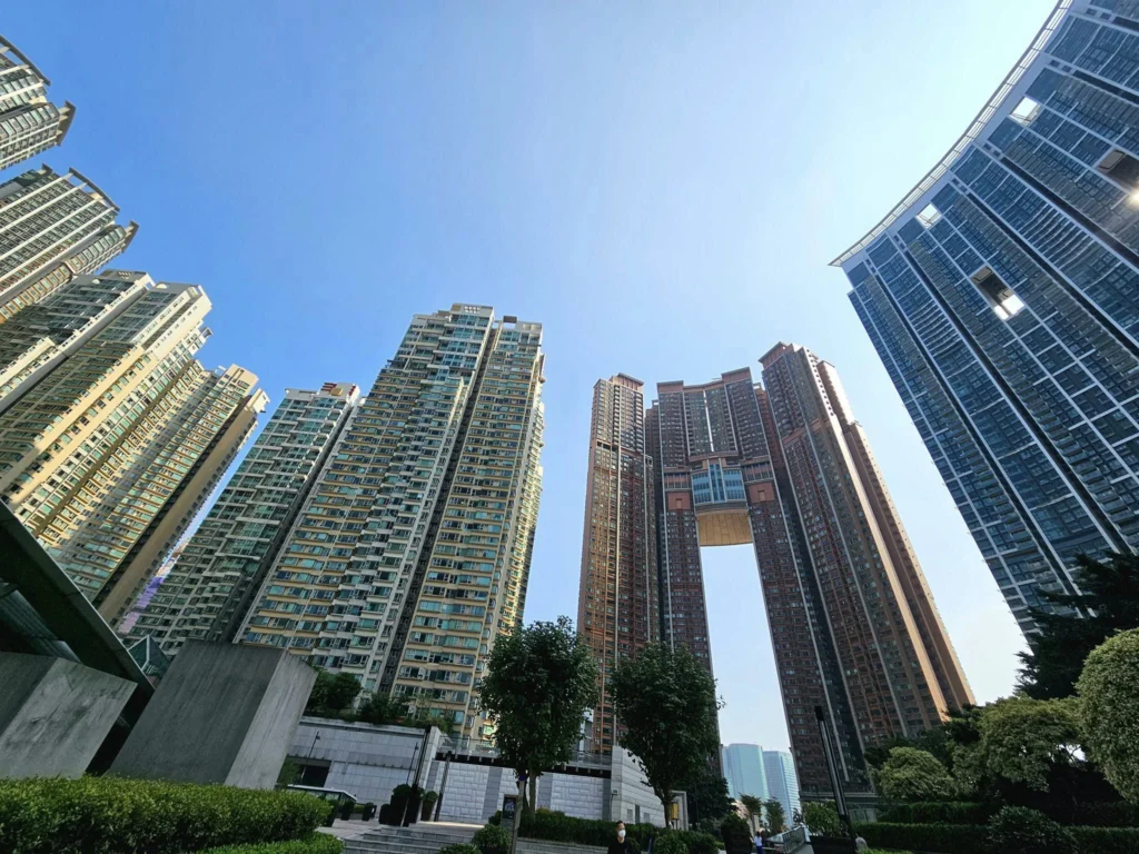Cruising with Danny and Peter, Holland America Line, Westerdam, Hong Kong, China, Hong Kong Travel Guide: 10 Irresistible Gems | Panoramic Hong Kong Skyline Views from Sky100 Observation Deck showcasing Victoria Harbour and glittering skyscrapers at dusk, paired with a vibrant Temple Street Market scene featuring colorful stalls offering Hong Kong Street Food like dim sum, egg tarts, wonton noodles, and crispy fish balls in a bustling Hong Kong Night Markets atmosphere, alongside a scenic Tsim Sha Tsui Promenade view of Victoria Harbour with illuminated Hong Kong Skyline Views perfect for Hong Kong Tourism evenings, and the Holland America Line’s Westerdam docked in Hong Kong, marking the end of a Cruise Travel Hong Kong journey with Hong Kong Attractions in the background.