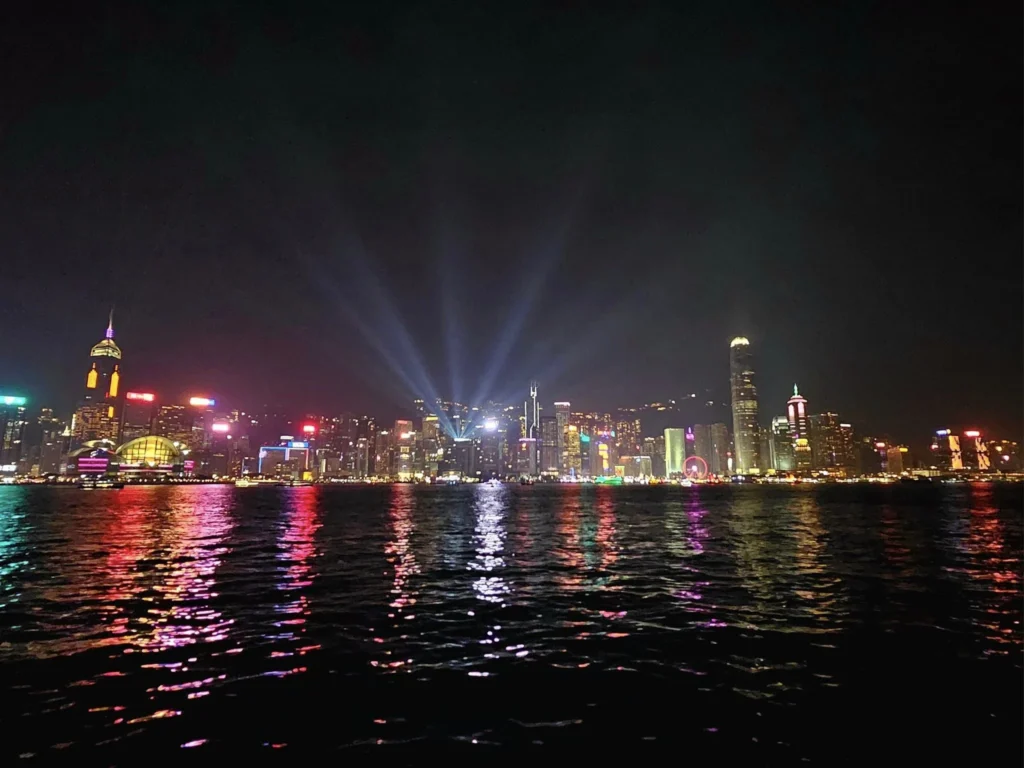 Cruising with Danny and Peter, Holland America Line, Westerdam, Hong Kong, China, Hong Kong Travel Guide: 10 Irresistible Gems | Panoramic Hong Kong Skyline Views from Sky100 Observation Deck showcasing Victoria Harbour and glittering skyscrapers at dusk, paired with a vibrant Temple Street Market scene featuring colorful stalls offering Hong Kong Street Food like dim sum, egg tarts, wonton noodles, and crispy fish balls in a bustling Hong Kong Night Markets atmosphere, alongside a scenic Tsim Sha Tsui Promenade view of Victoria Harbour with illuminated Hong Kong Skyline Views perfect for Hong Kong Tourism evenings, and the Holland America Line’s Westerdam docked in Hong Kong, marking the end of a Cruise Travel Hong Kong journey with Hong Kong Attractions in the background.