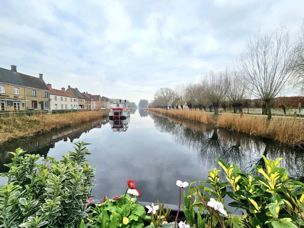 Cruising with Danny and Peter, MSC Cruises, MSC Preziosa, Zeebrugge, Brussels, Belgium, Exploring Loppem Castle in Flanders, a stunning example of Neo-Gothic Belgium architecture, surrounded by lush gardens and an intricate hedge maze. The historic canals of Flanders and Belgium medieval towns, including Damme bookshops and Bruges windmills, add to the region’s timeless charm. Inside the castle, beautifully preserved furnishings and stained-glass windows showcase the grandeur of Flanders historical sites. Indulging in Belgian chocolate tasting at Roose’s Chocolate World provides a sweet interlude. The Pieter Bruegel art tour and an MSC Northern Europe cruise complete this unforgettable Flanders travel experience.