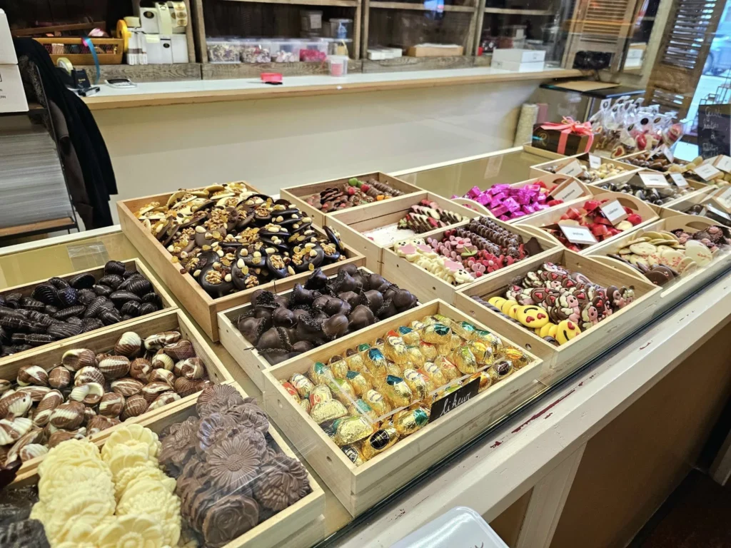 Cruising with Danny and Peter, MSC Cruises, MSC Preziosa, Zeebrugge, Brussels, Belgium, Exploring Loppem Castle in Flanders, a stunning example of Neo-Gothic Belgium architecture, surrounded by lush gardens and an intricate hedge maze. The historic canals of Flanders and Belgium medieval towns, including Damme bookshops and Bruges windmills, add to the region’s timeless charm. Inside the castle, beautifully preserved furnishings and stained-glass windows showcase the grandeur of Flanders historical sites. Indulging in Belgian chocolate tasting at Roose’s Chocolate World provides a sweet interlude. The Pieter Bruegel art tour and an MSC Northern Europe cruise complete this unforgettable Flanders travel experience.