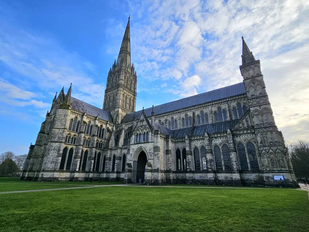 Cruising with Danny and Peter, MSC Cruises, MSC Preziosa, Southamton, London, England, United Kingdom, Stonehenge & Salisbury Tour, A breathtaking view of the Ancient Stone Circle at Stonehenge, showcasing its massive standing stones against the backdrop of the Wiltshire Countryside Trip. Visitors exploring this iconic Neolithic Monument Visit, a renowned UNESCO Heritage Site, as part of the MSC Preziosa Stonehenge and Salisbury Excursion. The towering spire of Salisbury Cathedral, the highlight of the Salisbury Cathedral Tour, stands majestically, housing the historic Magna Carta Exhibit. A scenic drive through the charming English villages on the English Countryside Tour, leading to a fascinating Medieval Town Exploration in Salisbury. This Southampton Shore Excursion offers an unforgettable journey through Historic England Landmarks, blending ancient wonders with medieval splendor.