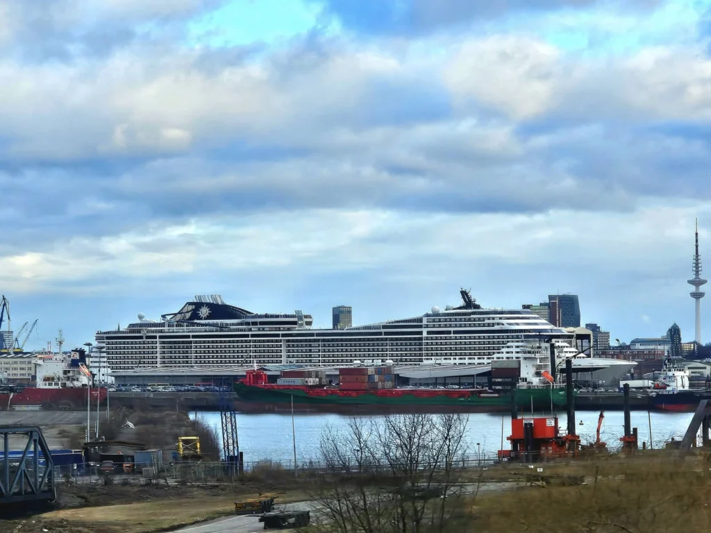 Cruising with Danny and Peter, MSC Cruises, MSC Preziosa, Hamburg, Germany, Lubeck City Tour showcasing the Holsten Gate, a historic medieval landmark with iconic round towers; St. Mary’s Church, known for its Gothic architecture and the world’s largest mechanical organ; charming cobblestone streets and UNESCO Heritage sites of Lubeck, reflecting its Hanseatic League history; traditional German lunch featuring bratwurst, sauerkraut, pretzels, and Lubeck’s famous marzipan, offering a taste of the city’s cultural and culinary heritage.